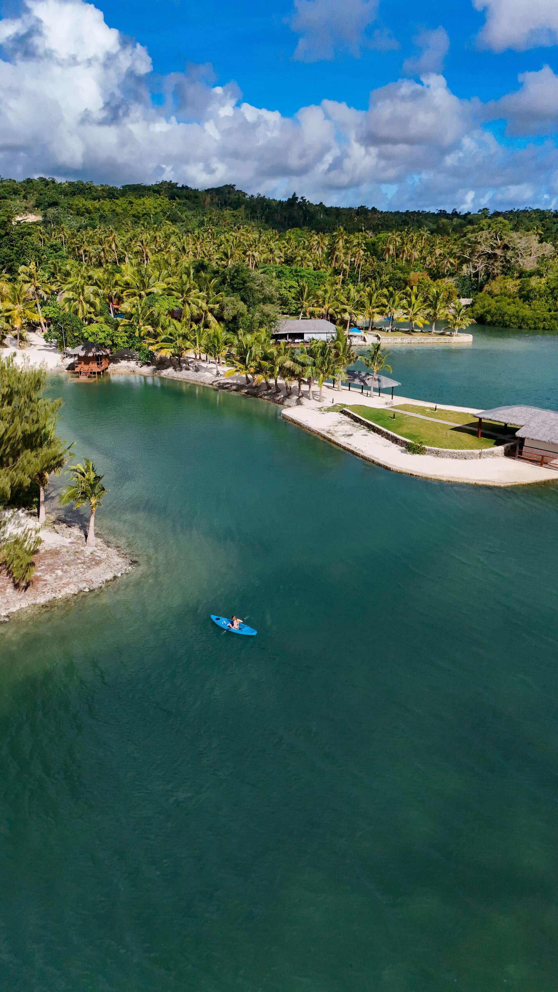 E'Nauwi Beach Resort aerial view of the lagoon and palm trees